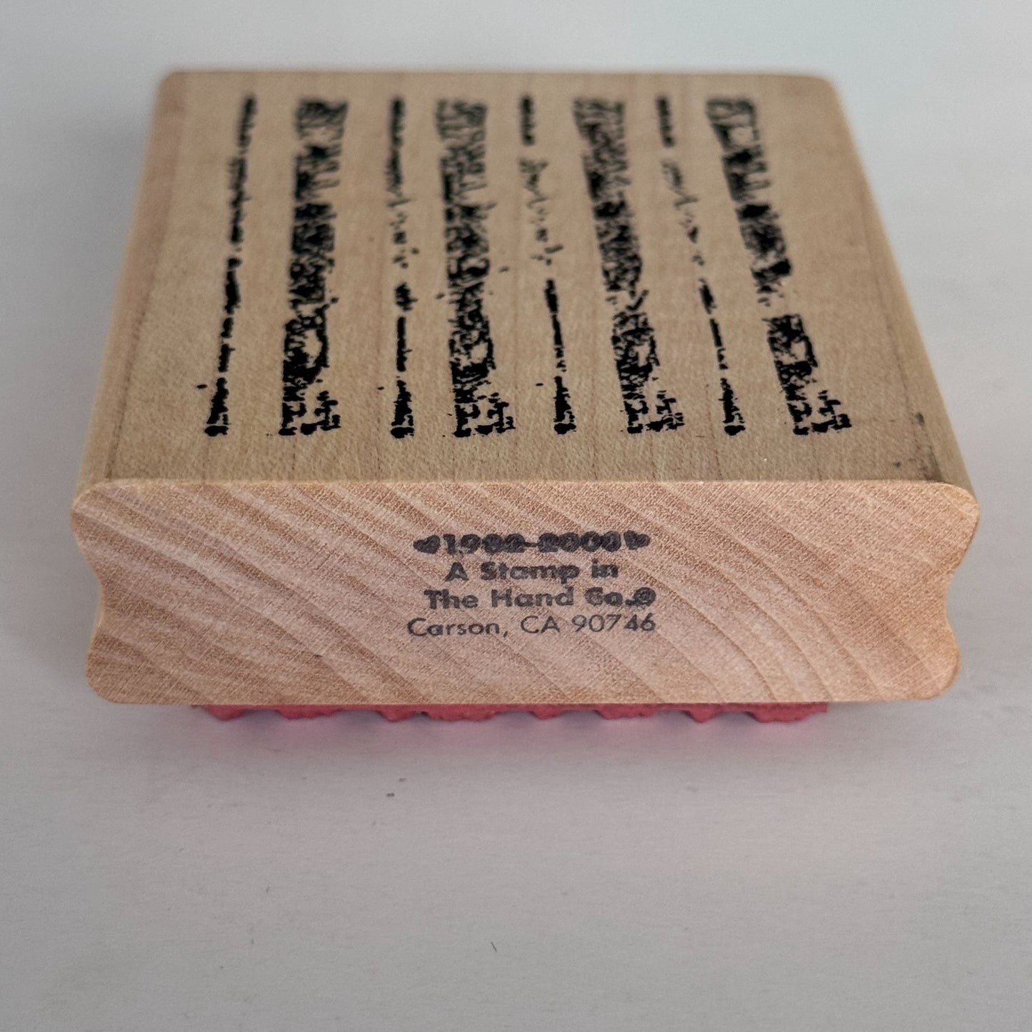 A Stamp In The Hand Rubber Stamp Distressed Lines Background Stripes Grunge Wood Texture