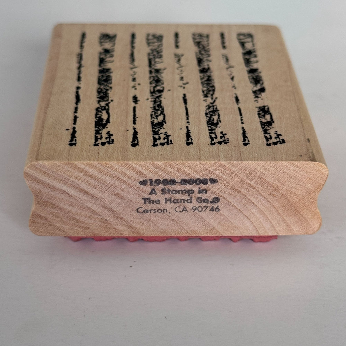 A Stamp In The Hand Rubber Stamp Distressed Lines Background Stripes Grunge Wood Texture