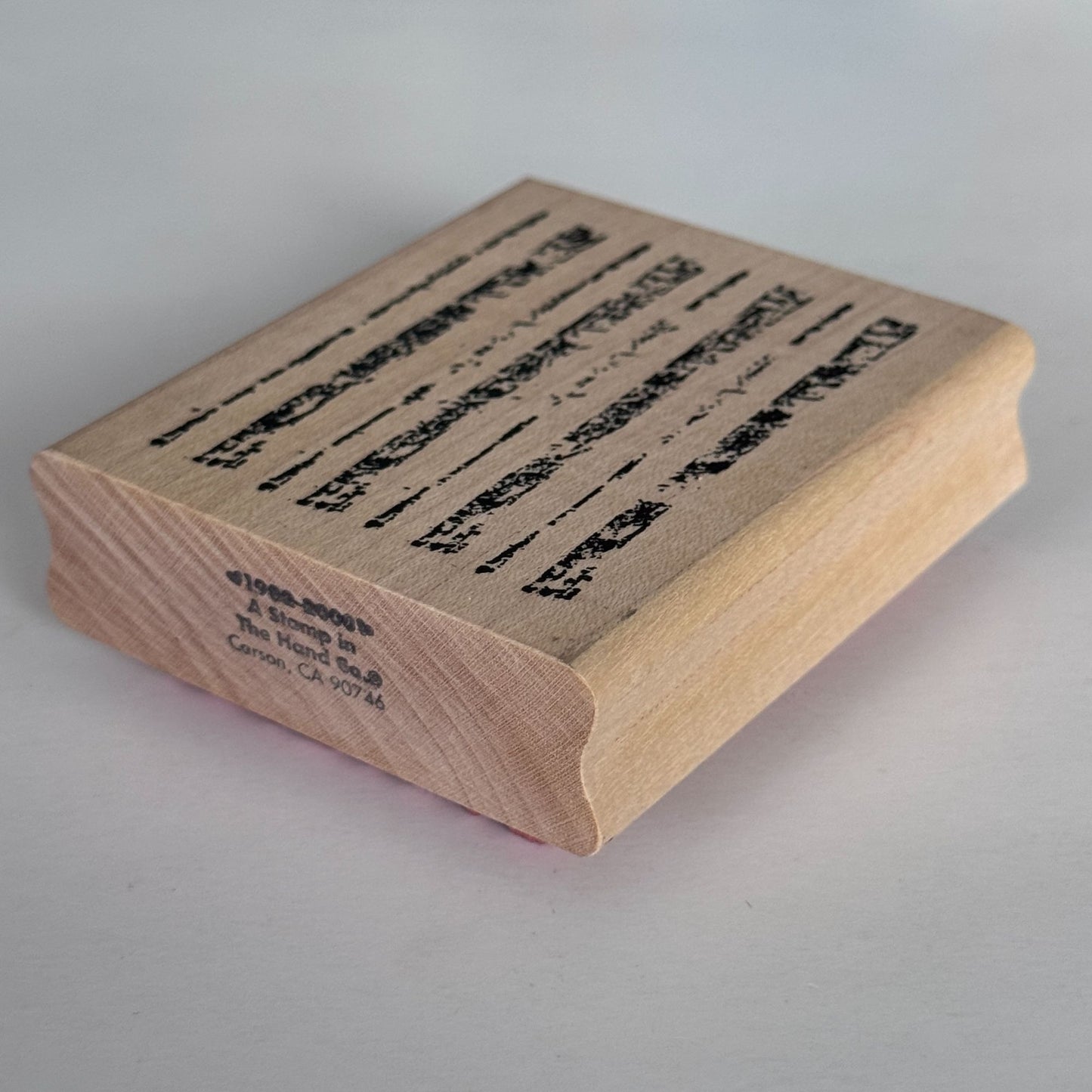 A Stamp In The Hand Rubber Stamp Distressed Lines Background Stripes Grunge Wood Texture
