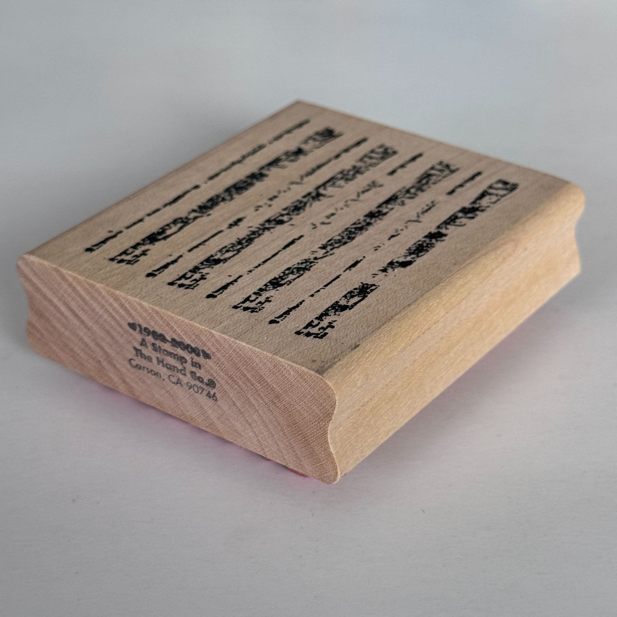 A Stamp In The Hand Rubber Stamp Distressed Lines Background Stripes Grunge Wood Texture